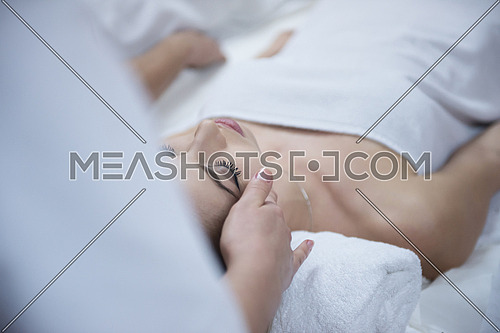 beautiful young woman getting face and head  massage in spa and wellness salon