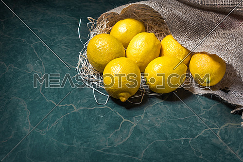 Lemons spilling from a jute sack