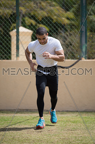 young middle eastern man athlete training running on the pitch on a sunny day