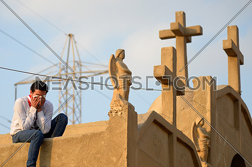 A young man cries during the burial of victims of the Egyptian al Botrouseya church bombing in Egypt