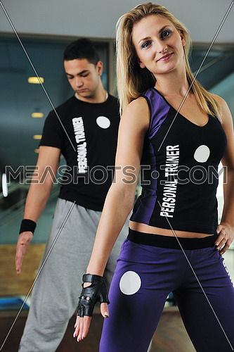 fitness personal trainer in fitness club exercise with client