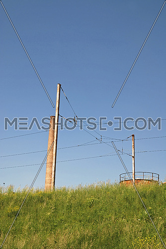 Electric power cable line crossing green nature landscape