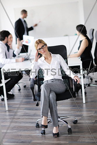 business woman  with her staff,  people group in background at modern bright office indoors