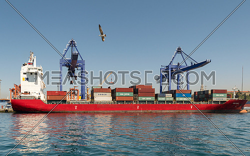 Istanbul, Turkey - April 26 2017: Loaded container ship named King Basil, at the shipyard of the Port of Haydarpasha with two big cranes, at Kadikoy district