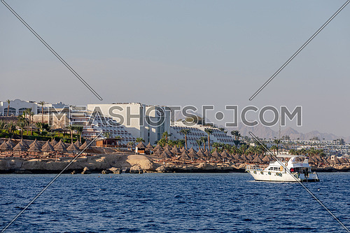 Long shot for yacht sailing showing Sheraton Hotel in Sharm El Shaikh City by day