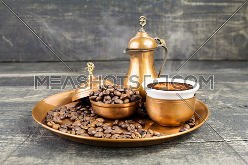 Turkish coffee with traditional copper serving set and coffee beans