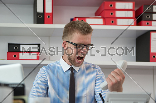 Angry Businessman Yelling Into A Phone