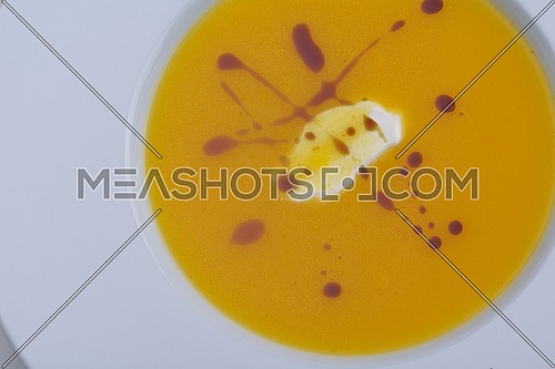 vegetable cream soup closeup isolated on white background