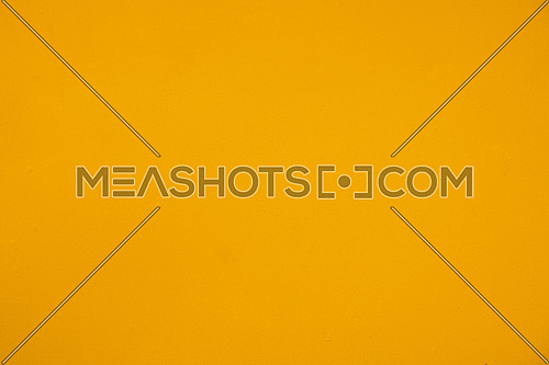 Close up background of uneven vivid yellow painted metal surface