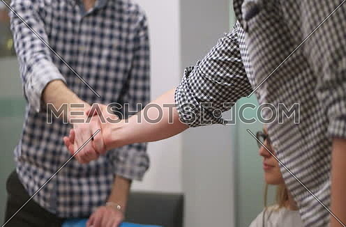 business people having meeting and shaking hands on deal