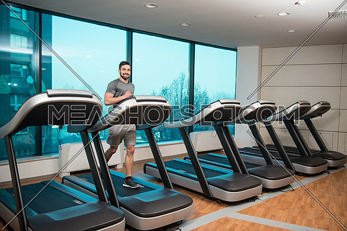 Handsome Man Running On The Treadmill In Gym