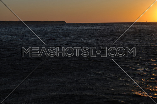 romantic sunset at sea eith tourist and travel boats on horizon