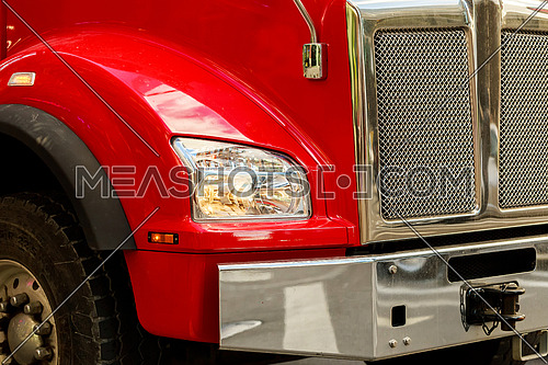 Front end of a semi truck while parked red truck