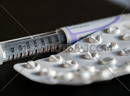 Insulin pencil with empty pill pack, conceptual image