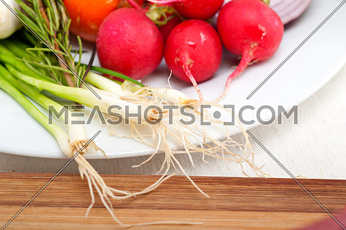 fresh vegetables and herbs on a plate cooking raw ingredients on kitchen