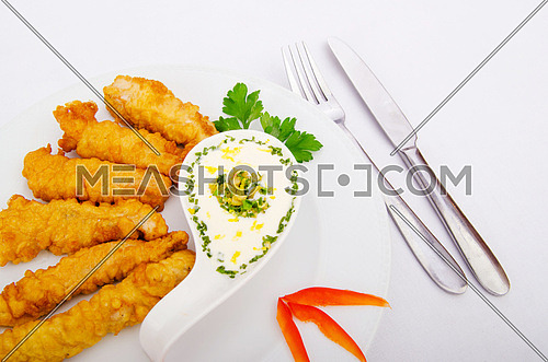 Battered chicken served with sauce