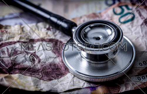 Stethoscope on banknotes Bolivarian, shady deal of medicines in full crisis of Latin American country, conceptual image