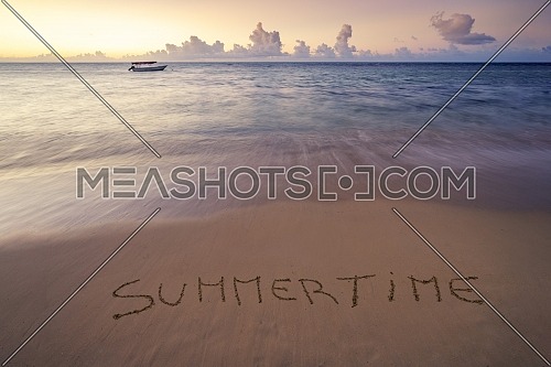 Handwritten Summertime on sandy beach at sunset,relax and summer concept,Dominican republic beach.