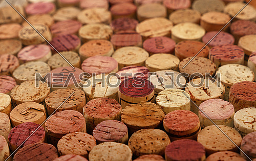 Close up background pattern of many assorted stacked used red wine corks, high angle view