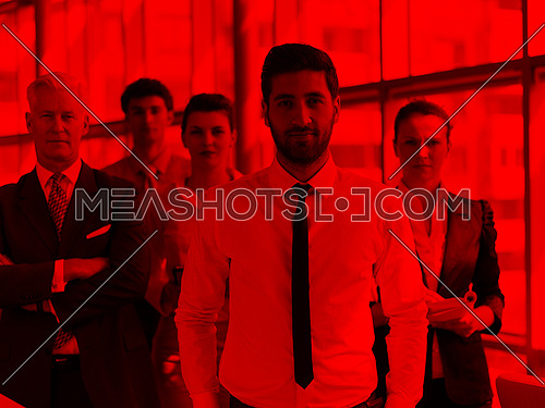 portrait of business people group at modern bright office, young arab man with beard standing in front as leader