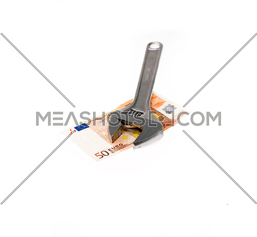 wrench tool fixing euro bill isolated on white background  closeup