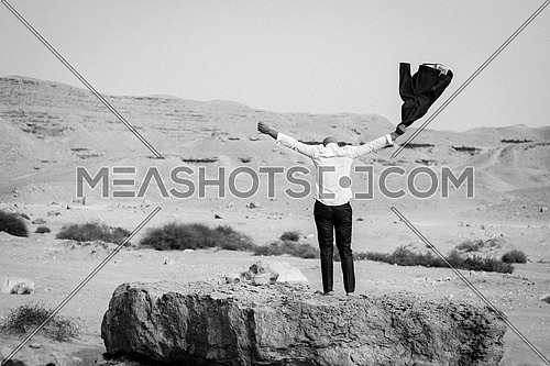 business Man Celebrating alone in the desert