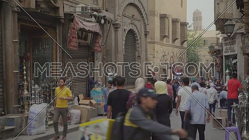 Fixed shot for people walking in El Moez Street in Cairo at day