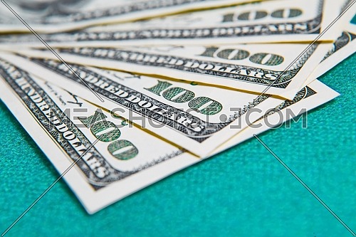 US dollars on green table