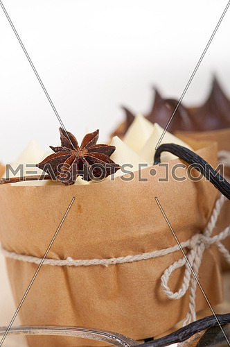 fresh baked chocolate vanilla and spices cream cake dessert over rustic wood table 