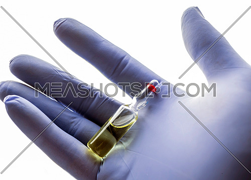 Detail of hand medical holding a vial, conceptual image