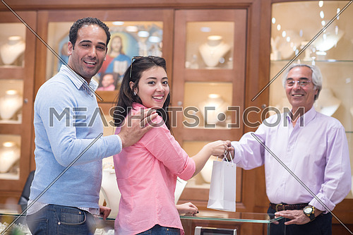 Young middle eastern happy couple enjoying while buying in a luxury jewelry store