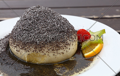 Parena buchta, steamed sweet dumpling bun topped with poppy seeds, sugar and butter, traditional in Slovakia, Hungary and Austria, close up, high angle view