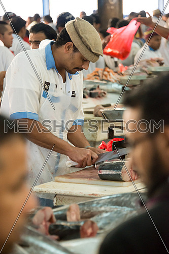 sales man cutting fish in Fish Market In Dubai