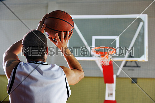 basketball game playeer shooting on basket indoor in gym