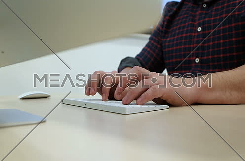 hands typing onk computer keyboard in startup office