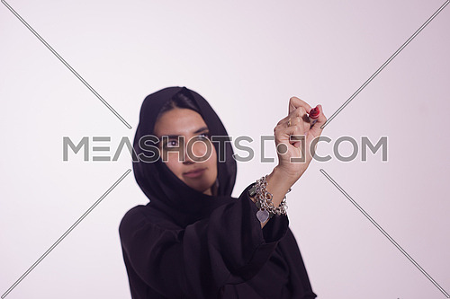 Arabian Middle eastern woman writing with marker on virtual screen isolated on white background