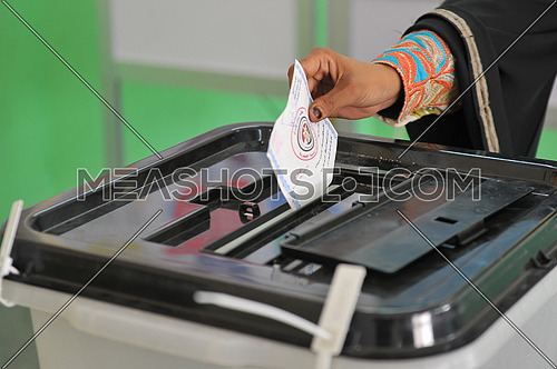 The hand of an Egyptian lady puts the ballot paper on the ballot box on the last day of the presidential elections in Dahab city in South Sinai