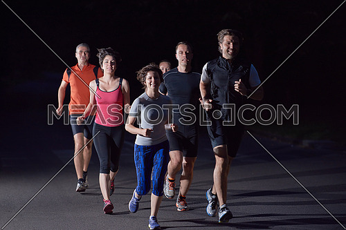 people group jogging at night, runners team on early morning  training