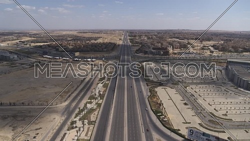 Aerial shot flying over Dahshour road at 6th of October City showing Mall of Arabia during the corona pandemic lockdown by day 10 April
