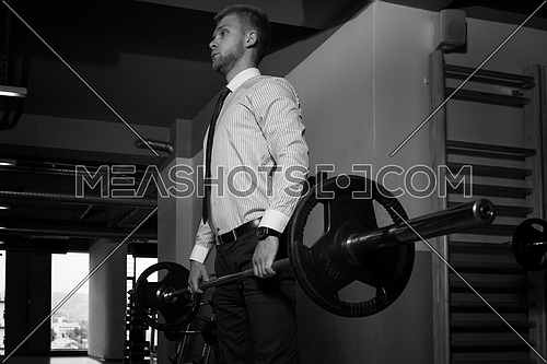 Young Business Man Doing Heavy Weight Exercise For Back In Gym