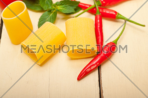 Italian pasta paccheri or schiaffoni with tomato mint and chili pepper ingredients