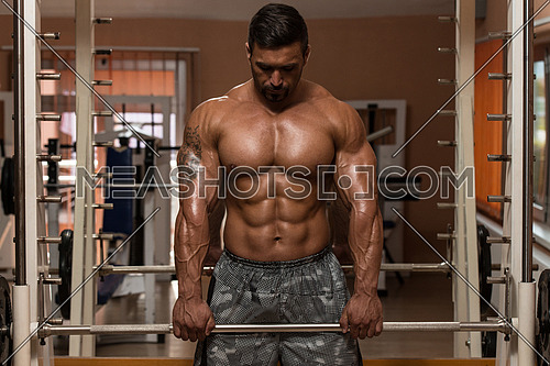 Bodybuilder Doing Heavy Weight Exercise For Trapezius