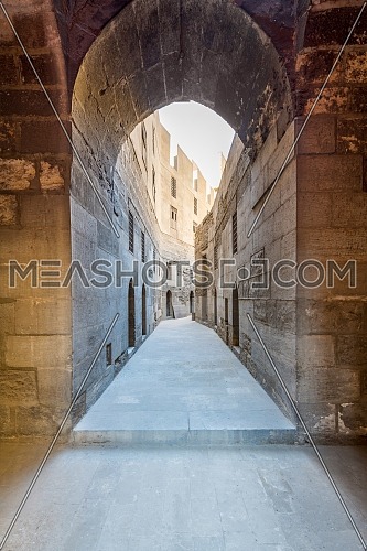 Narrow passage with old grunge stone walls leading to Sultan Hasan Mosque, Cairo, Egypt
