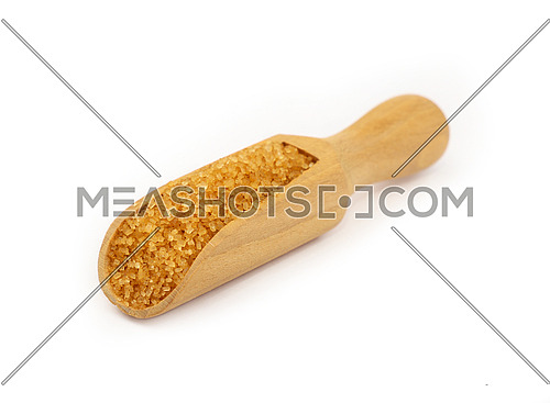Close up one wooden scoop spoon full of raw brown cane sugar isolated on white background, low angle view