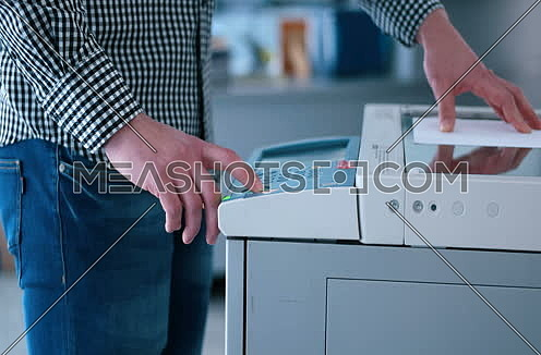 assistant makes copies of files in the copy machine 