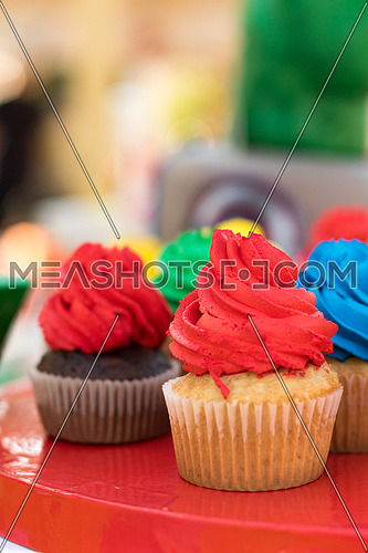 plate full of cupcakes with coloured frosting for kids