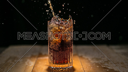 Glass of Cold Fizzy Drink on a wodden table