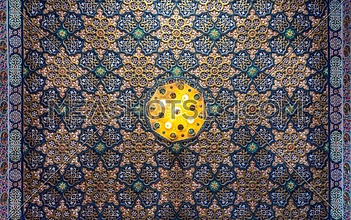 Colorful wooden ornate ceiling with floral and geometrical patterns at historic Manial Palace of Prince Mohammed Ali Tewfik, Cairo, Egypt