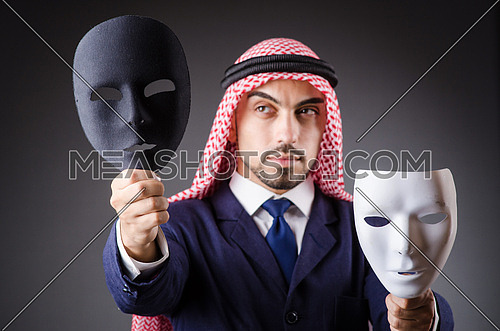 Arab with masks in dark studio