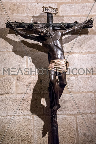 Caceres, Spain - july 13, 2018: Holy Crucifix of Santa Maria de Jesus (Black Christ) in your chapel, is an anonymous carving and is in the cathedral of Santa Maria, Caceres, Spain
